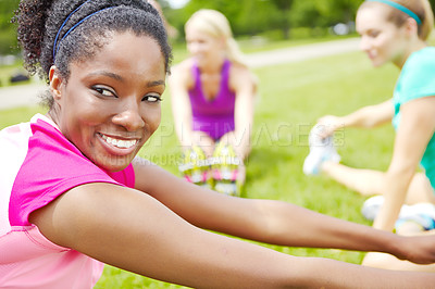 Buy stock photo Side view of a female athlete looking over her shoulder while stretching