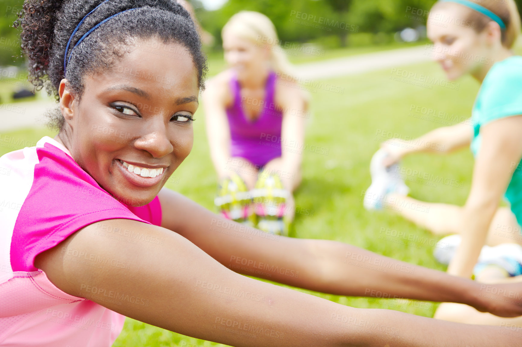 Buy stock photo Side view of a female athlete looking over her shoulder while stretching