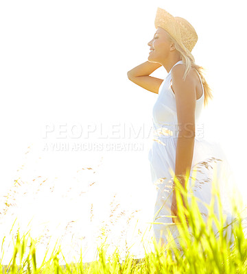 Buy stock photo A beautiful young blonde woman standing in a meadow wearing a sunhat on a sunny day