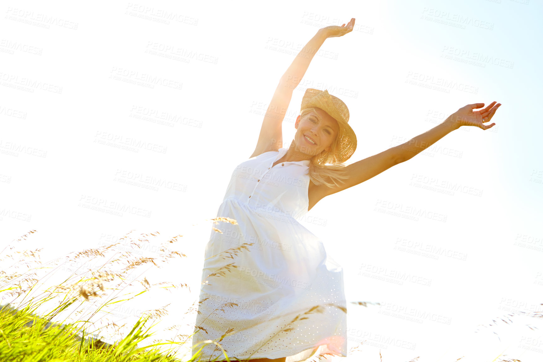 Buy stock photo Fashion, freedom and portrait of woman in nature for biodegradable, organic or sustainable clothes. Hands raised, smile and zero waste with person in countryside for cruelty free style from below