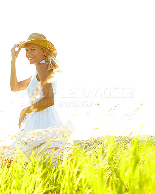 Buy stock photo A young woman in a field wearing a sunhat