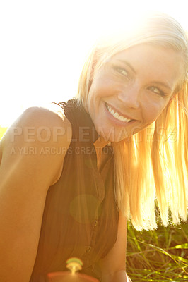 Buy stock photo A beautiful young blonde woman sitting in a field