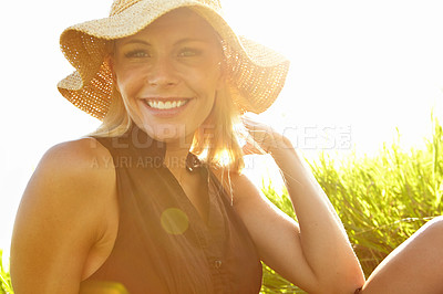 Buy stock photo A beautiful young blonde woman sitting in a field