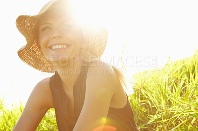 Buy stock photo Happy woman, sunshine and grass field with hat for summer holiday, weekend or vacation in nature. Female person, relax and sunlight with smile for travel, trip or outdoor adventure in countryside