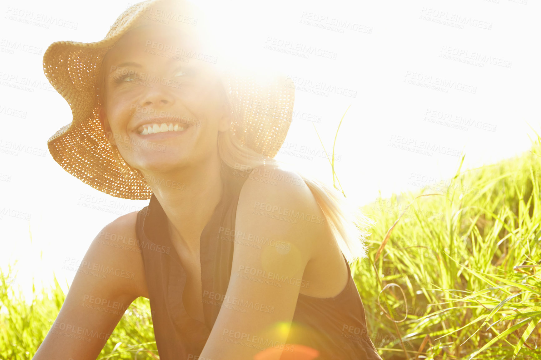 Buy stock photo A beautiful young blonde woman sitting in a field