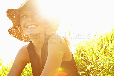 Buy stock photo A beautiful young blonde woman sitting in a field