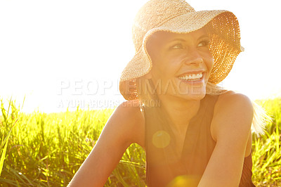 Buy stock photo A beautiful young blonde woman sitting in a field