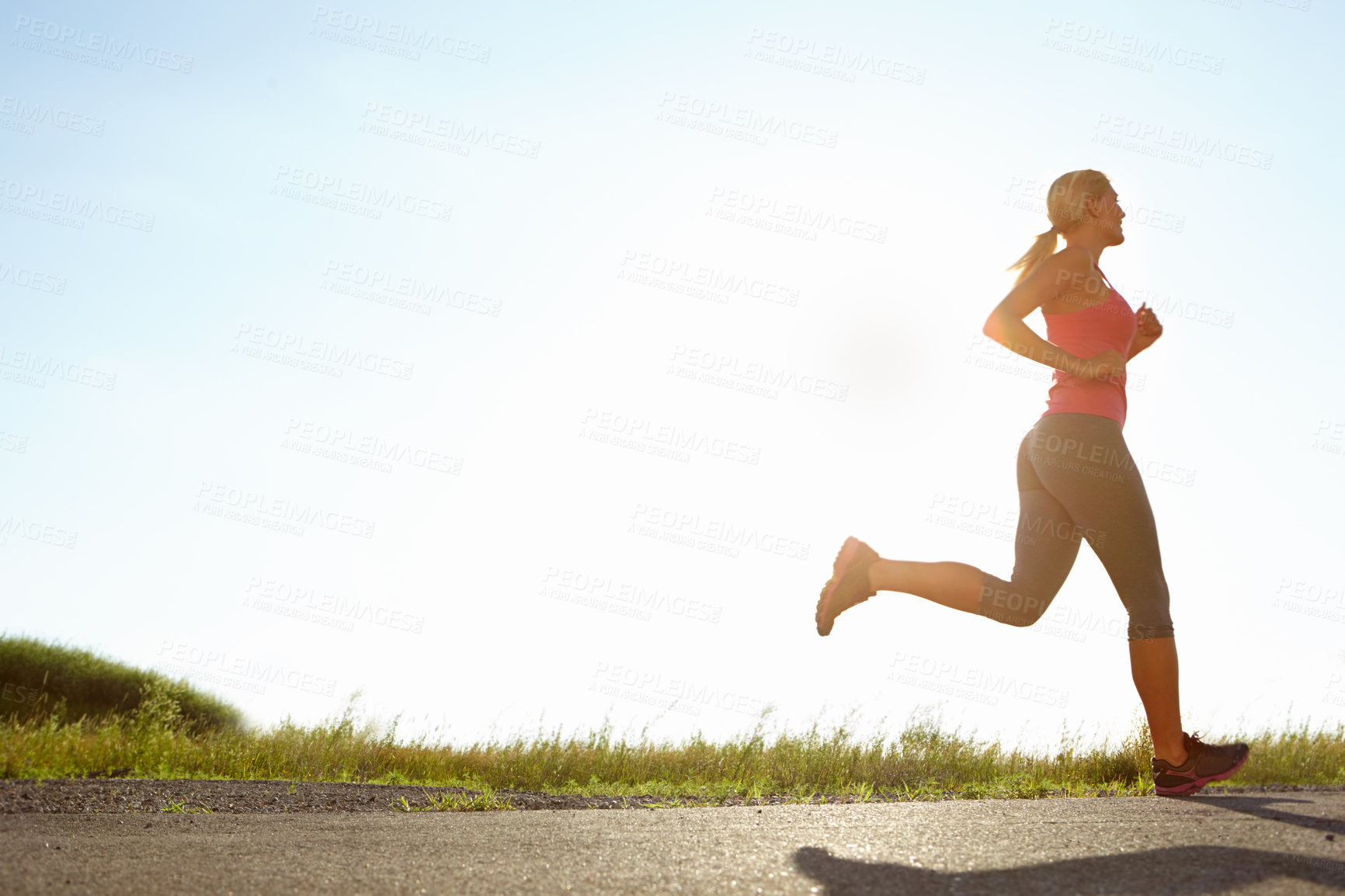 Buy stock photo A young woman running on a sunny day