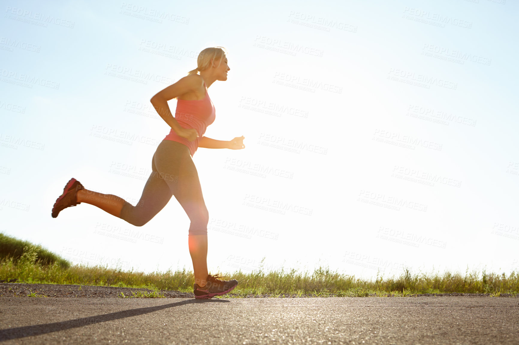 Buy stock photo A young woman running on a sunny day