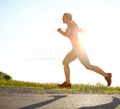 Buy stock photo A young woman running on a sunny day