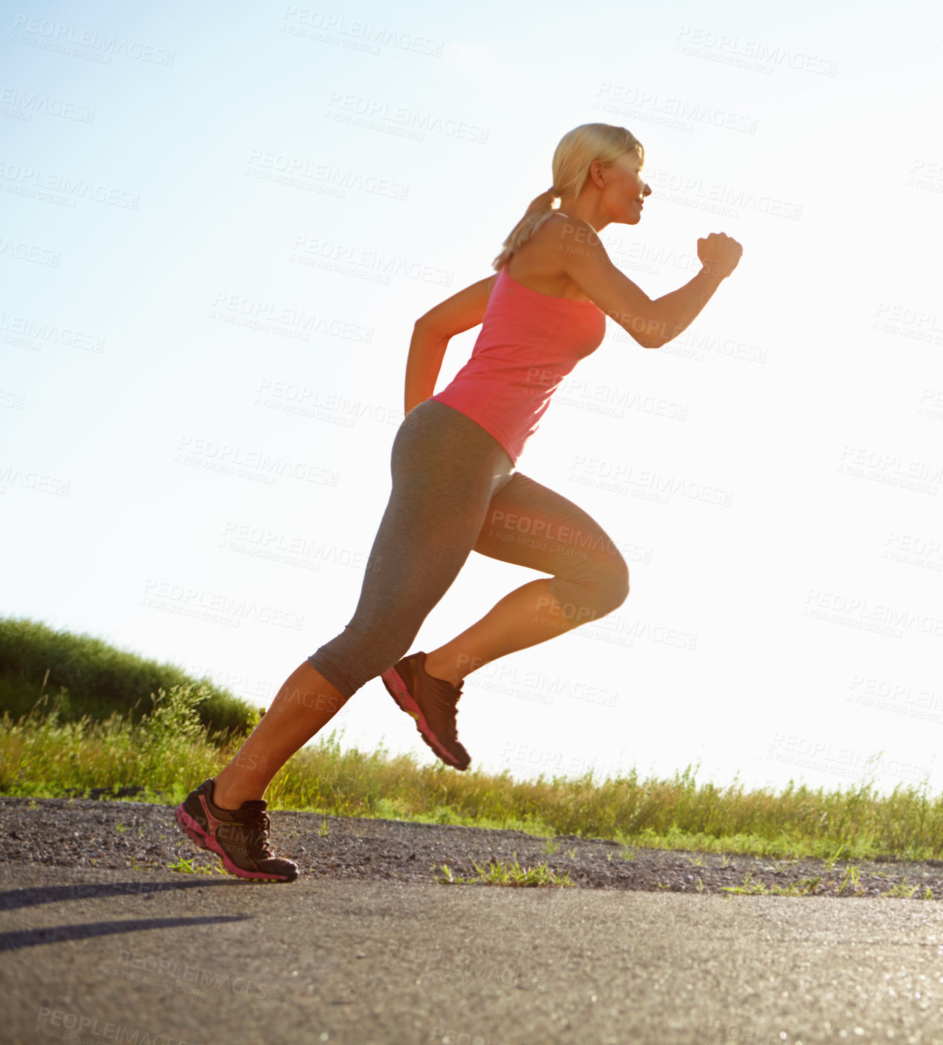 Buy stock photo A young woman running on a sunny day