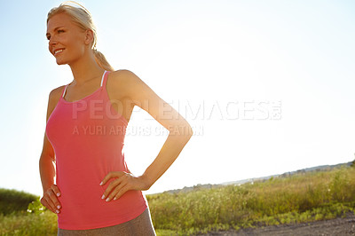 Buy stock photo A young woman in sporstwear relaxing after a jog