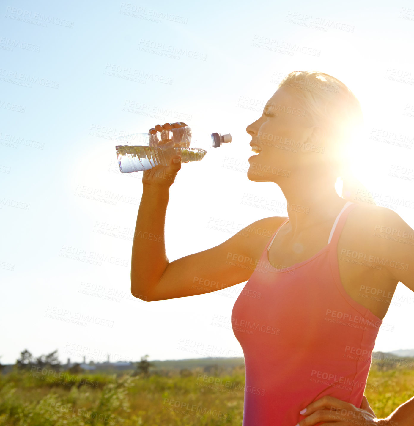 Buy stock photo A beautiful young woman in sportswear drinking water from a bottle