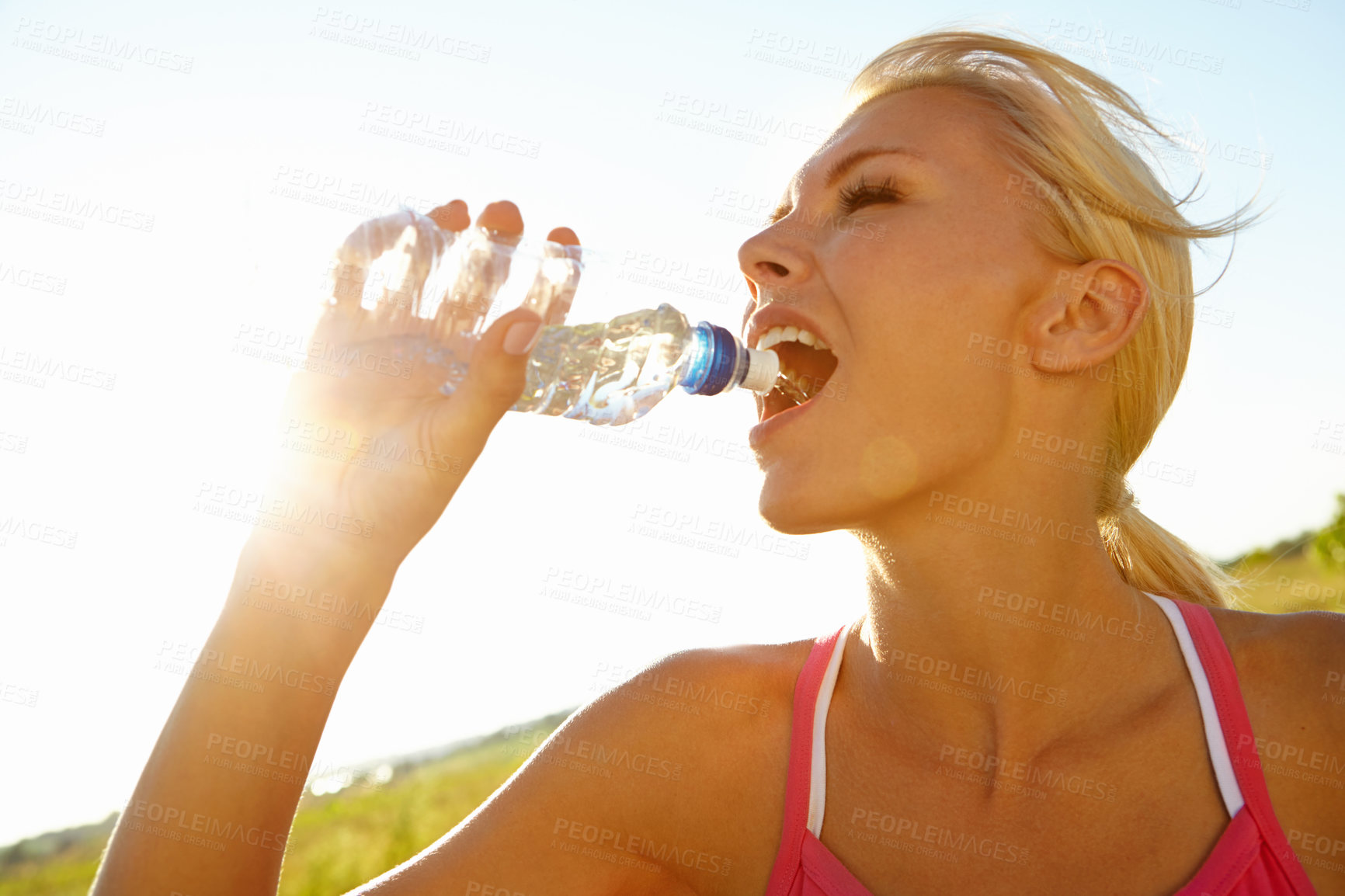 Buy stock photo A beautiful young woman in sportswear drinking water from a bottle