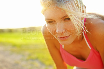 Buy stock photo A beautiful young woman in sportswear looking tired after a run