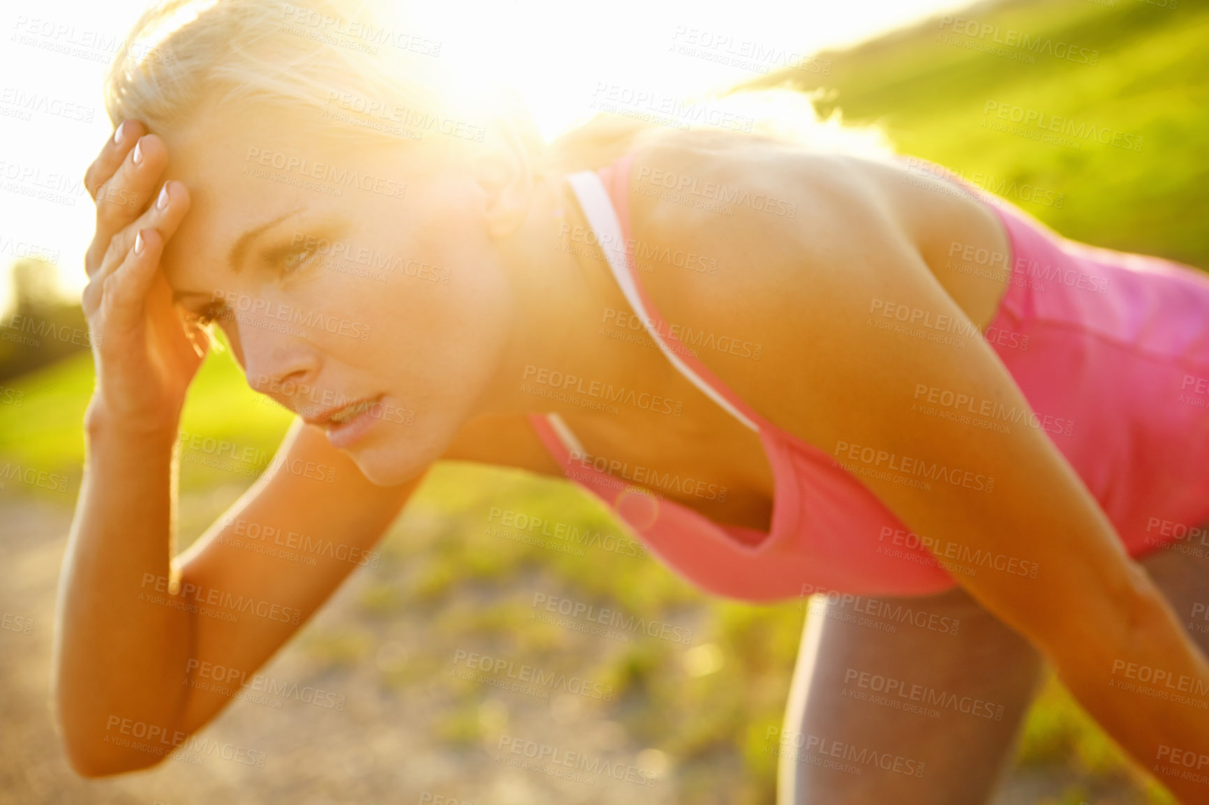 Buy stock photo A beautiful young woman in sportswear looking tired after a run