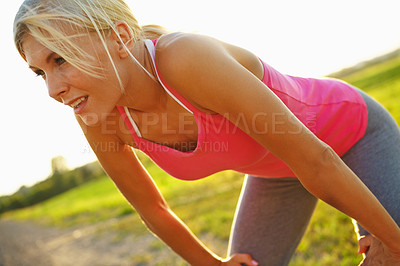 Buy stock photo A beautiful young woman in sportswear with hands on her knees