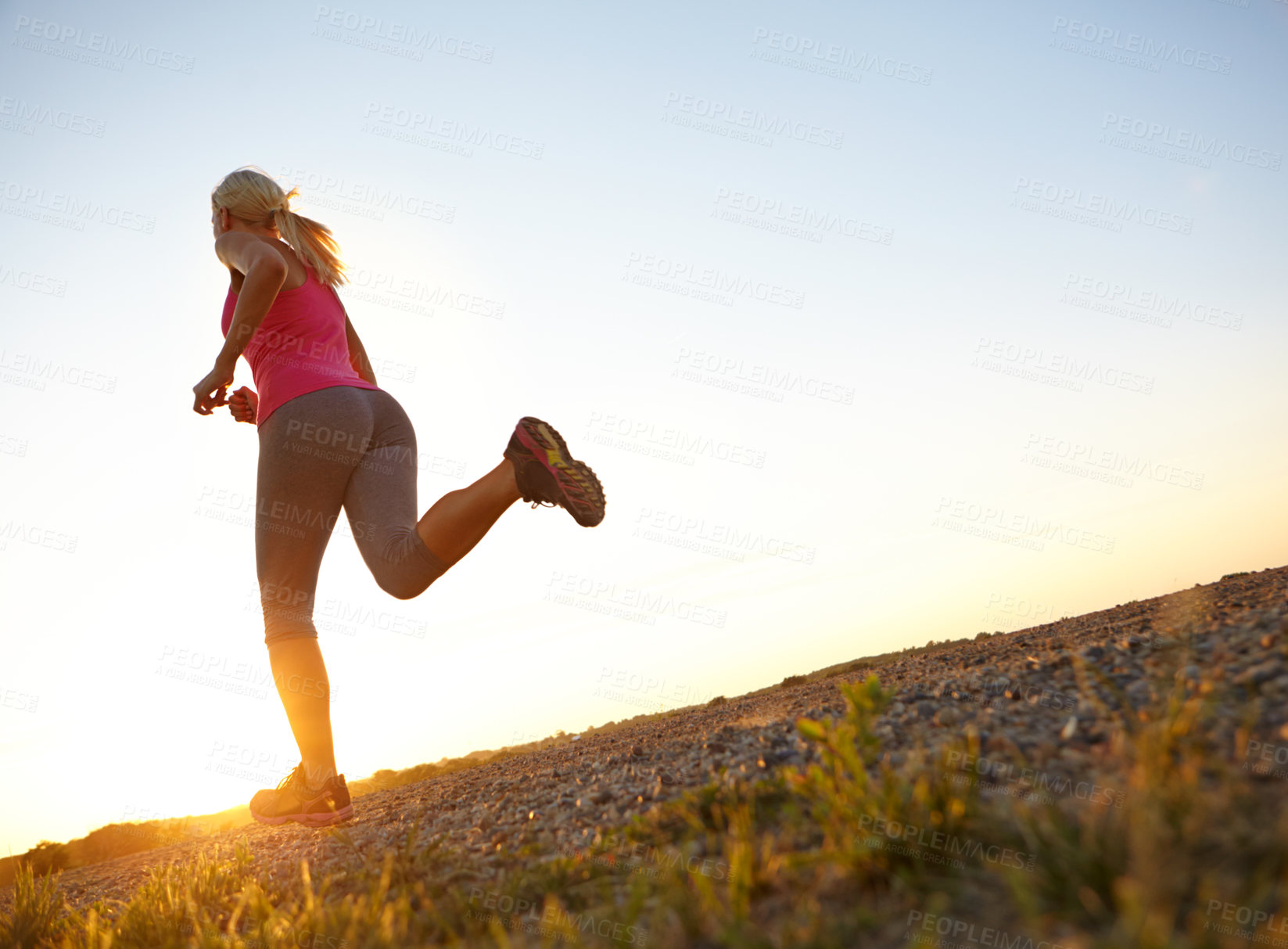 Buy stock photo Fitness, woman and running on dirt road for marathon training, healthy body and cardio challenge. Mockup space, person back and exercise on low angle for morning jog, workout performance or sprinting