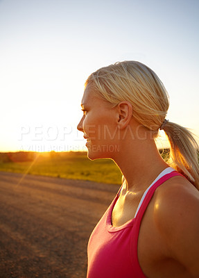 Buy stock photo A beautiful young sportswoman looking at the sunset