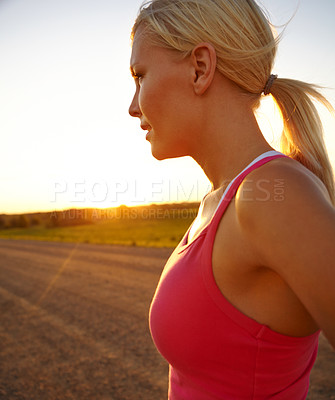 Buy stock photo A beautiful young sportswoman looking at the sunset