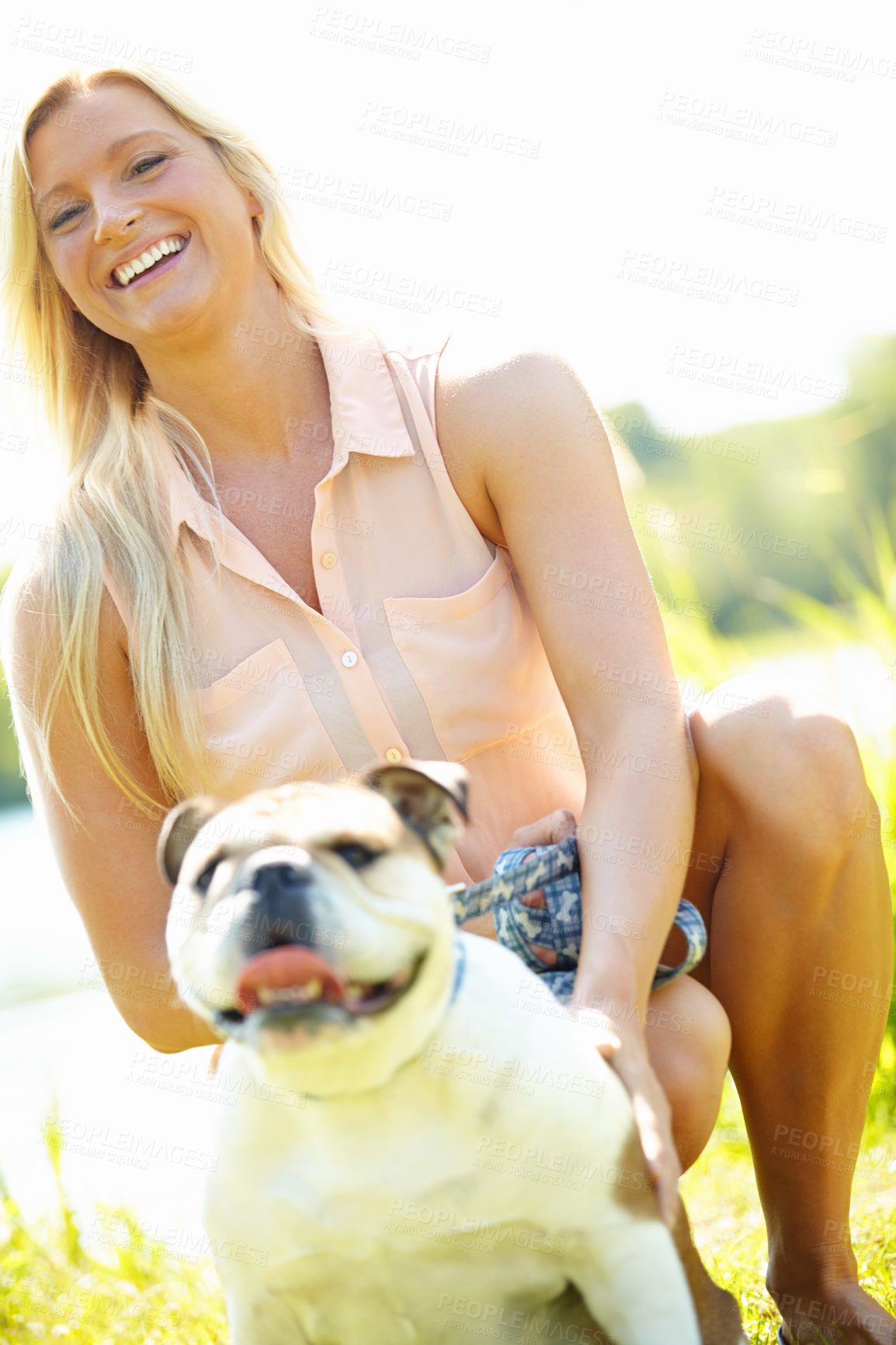 Buy stock photo Portrait of a smiling blonde woman outside with her bulldog