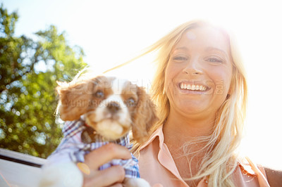 Buy stock photo Portrait of a pretty blonde holding a cute puppy