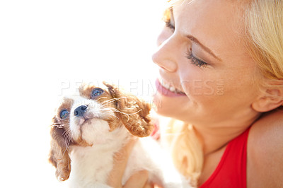 Buy stock photo Shot of a beautiful blonde hugging a cute puppy with copyspace