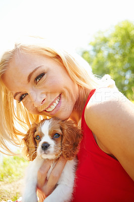 Buy stock photo Portrait of a happy woman hugging her puppy outside