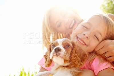 Buy stock photo Outdoor, woman and child with dog after adoption, puppy care and bonding together with happiness. Flare, mother and girl with Cavalier pet for companion, animal and connection with mockup in nature