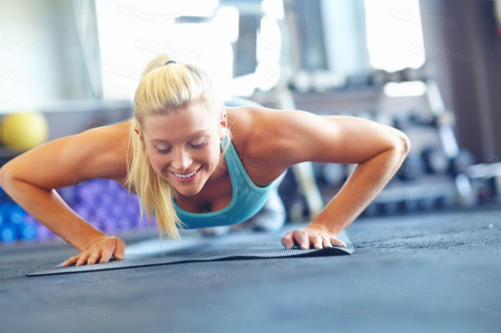 Buy stock photo Woman, push ups and happiness for sports, exercise and fitness for workout with yoga mat or balance. Female athlete, plank and performance in gym for training, strong muscle and toned body at pilates