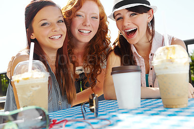 Buy stock photo A group of adolescent girls enjoying smoothies at an outdoor cafe