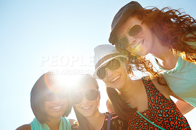 Buy stock photo A group of four teenage girls smiling with their arms around each other's shoulders