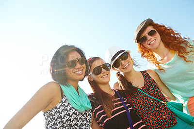 Buy stock photo A group of four teenage girls smiling with their arms around each other's shoulders