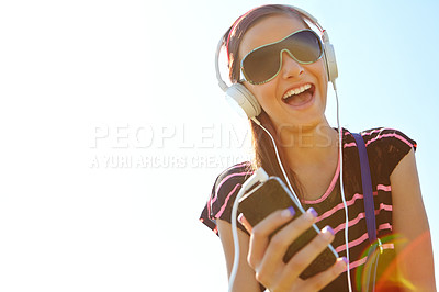 Buy stock photo A happy young teeanage girl listening to music over her headphones