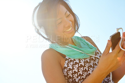 Buy stock photo Phone, music and happy girl with headphones outdoor for kpop, podcast and listening to rock. Mobile, audio and female person with radio app, social media and streaming service on internet by sky