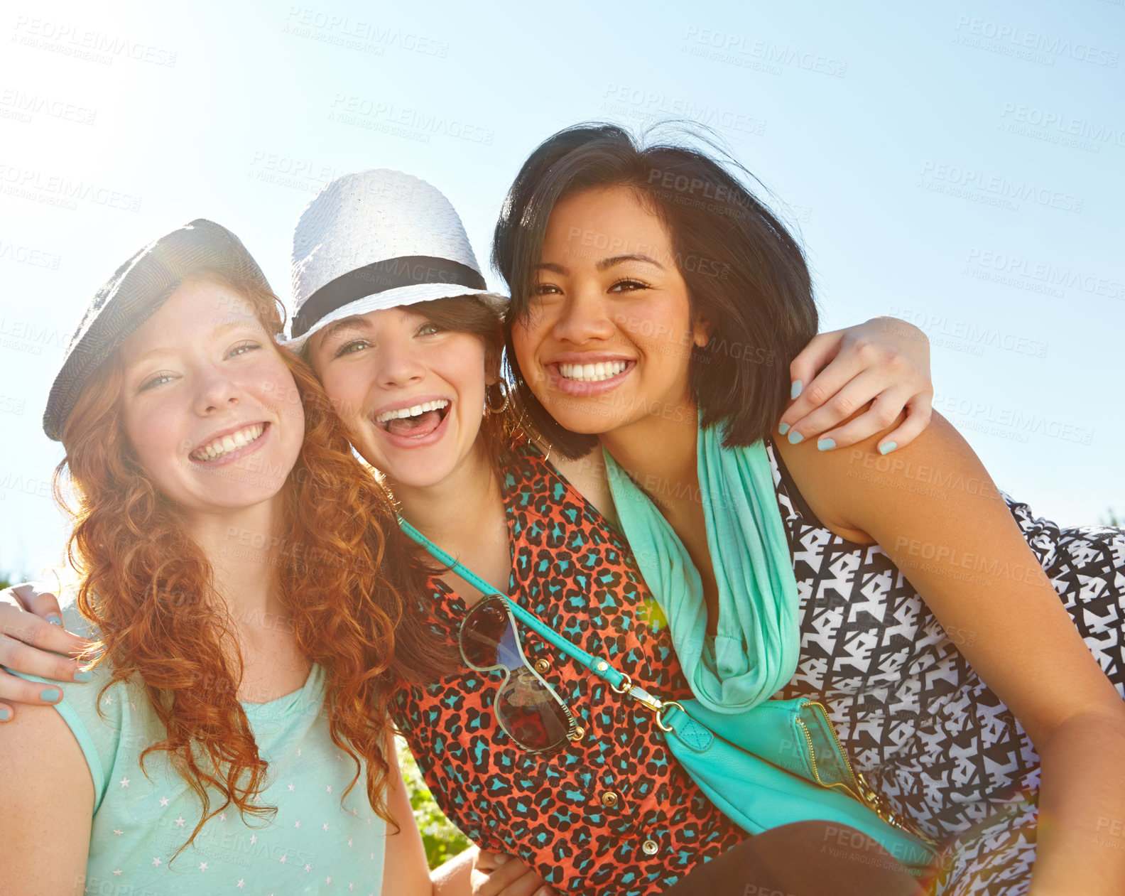 Buy stock photo Three teenage girls smiling happily with their arms around each other