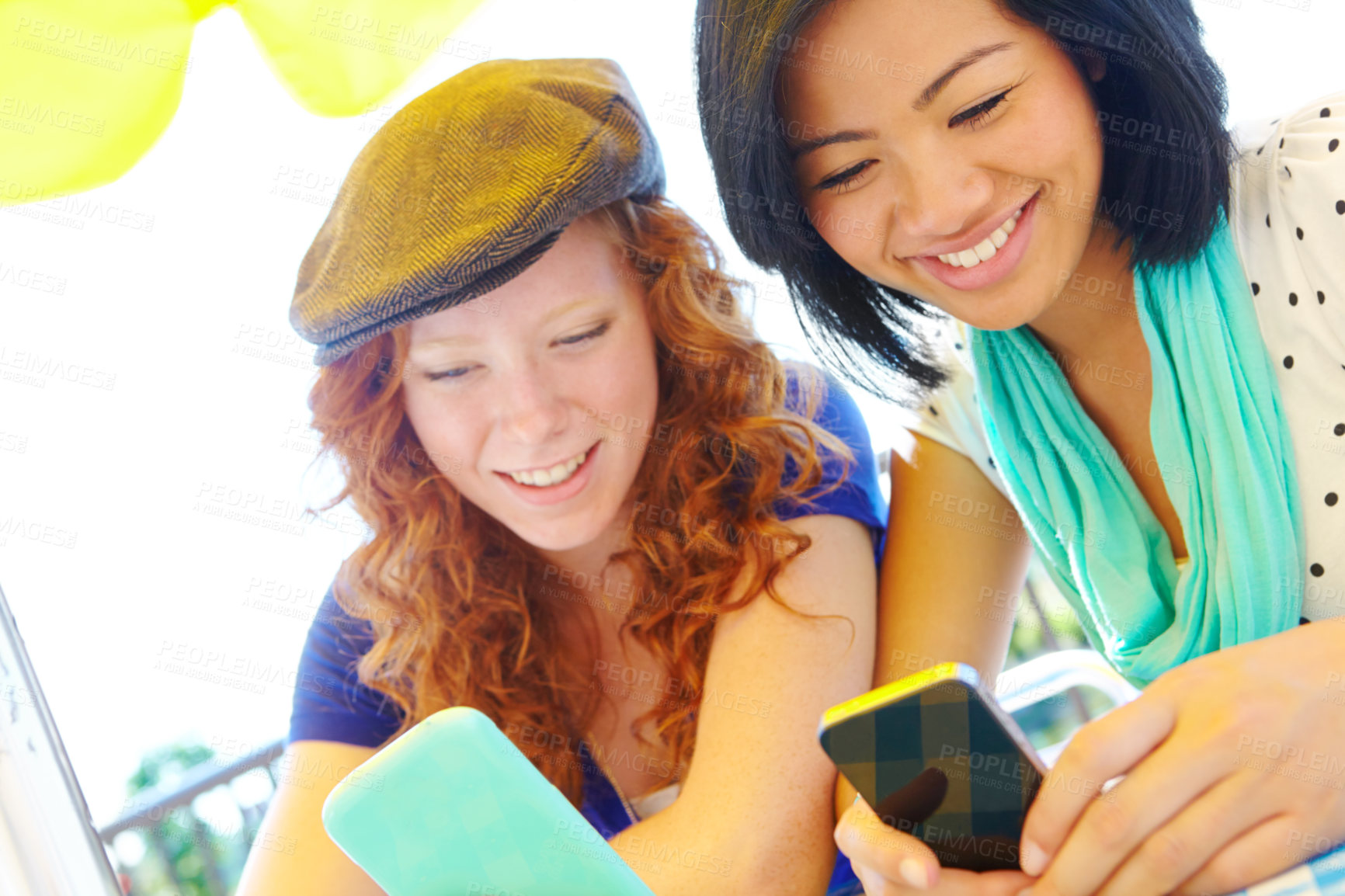 Buy stock photo Phone, outdoor and girl friends typing text for planning graduation trip together in group chat. Happy, cellphone and young teen in park reading travel blog for holiday advice, tips or guidance.