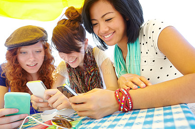 Buy stock photo A group of adolescent girls texting on their smartphones