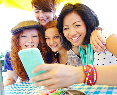 Buy stock photo Phone, portrait and group of girl friends with conversation for planning graduation trip together. Happy, cellphone and young women in park reading travel blog for holiday advice, tips or guidance.