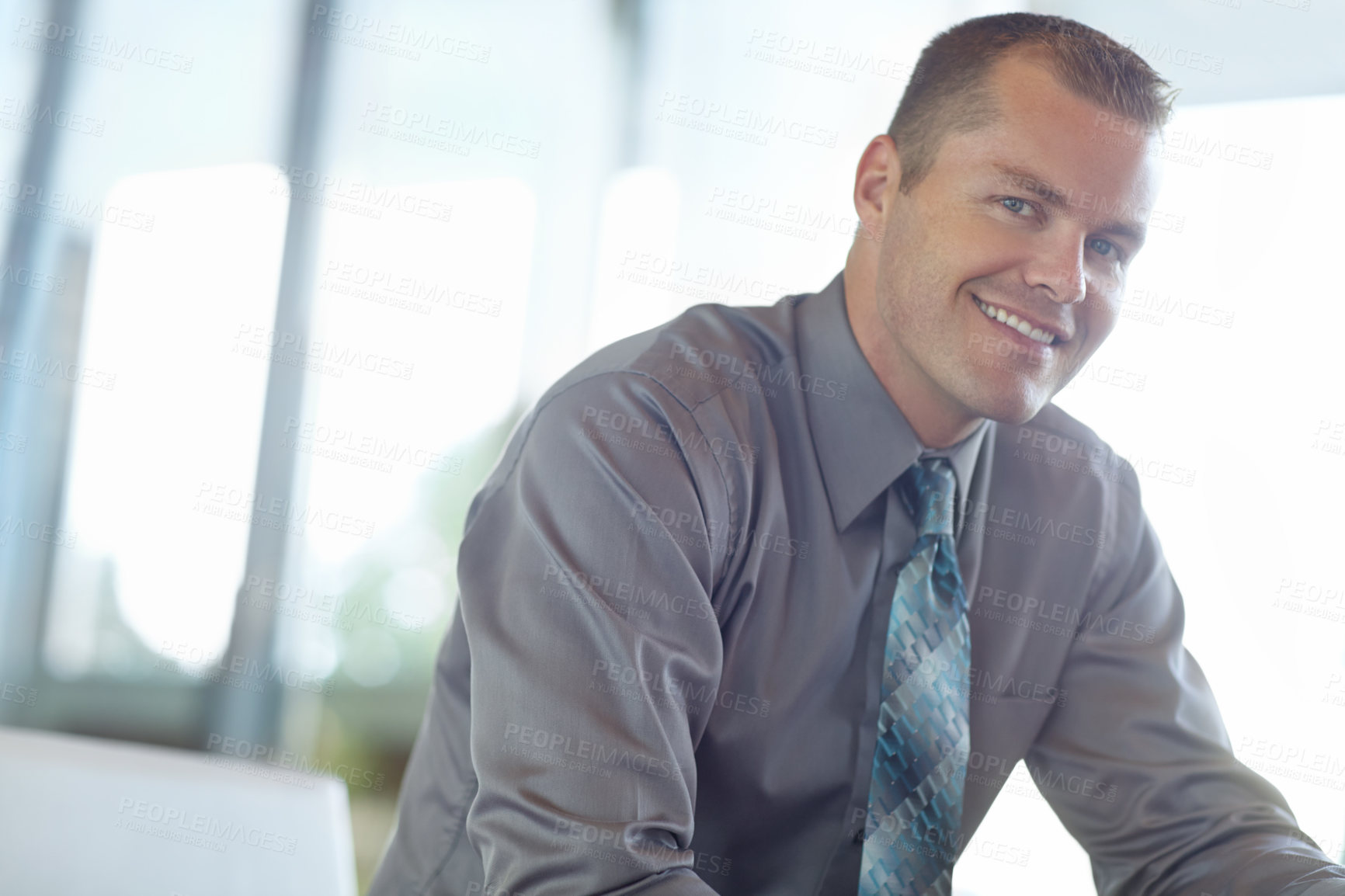 Buy stock photo Smiling caucasian businessman at work