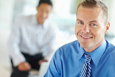 Buy stock photo Smiling caucasian businessman at work with his coworker in the background