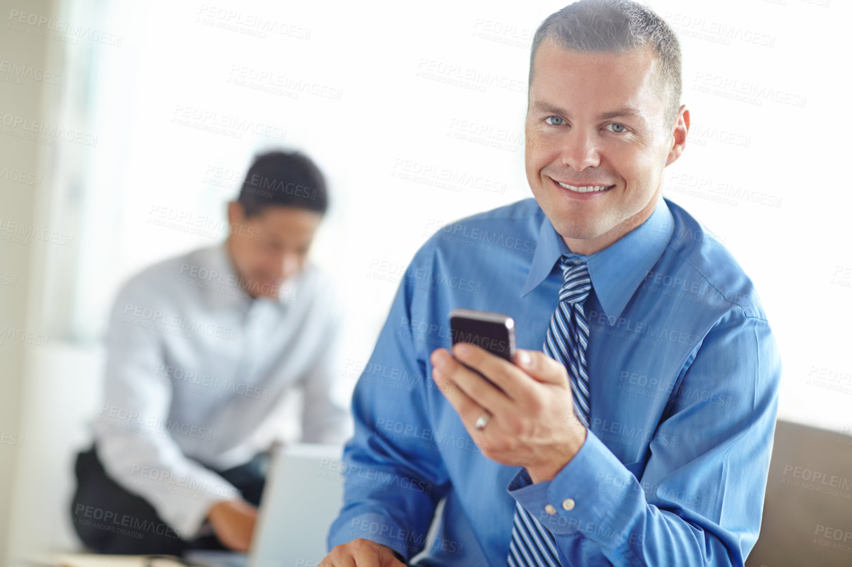 Buy stock photo Phone, portrait and smile of business man in lobby of office for communication or text message. App, contact and social media with professional employee in workplace for break or internet research