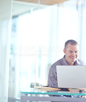 Buy stock photo Young caucasian businessman working on his laptop 