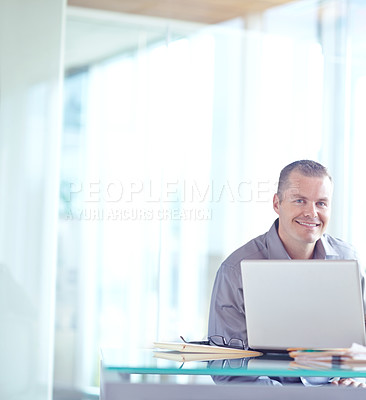 Buy stock photo Young caucasian businessman working on his laptop 
