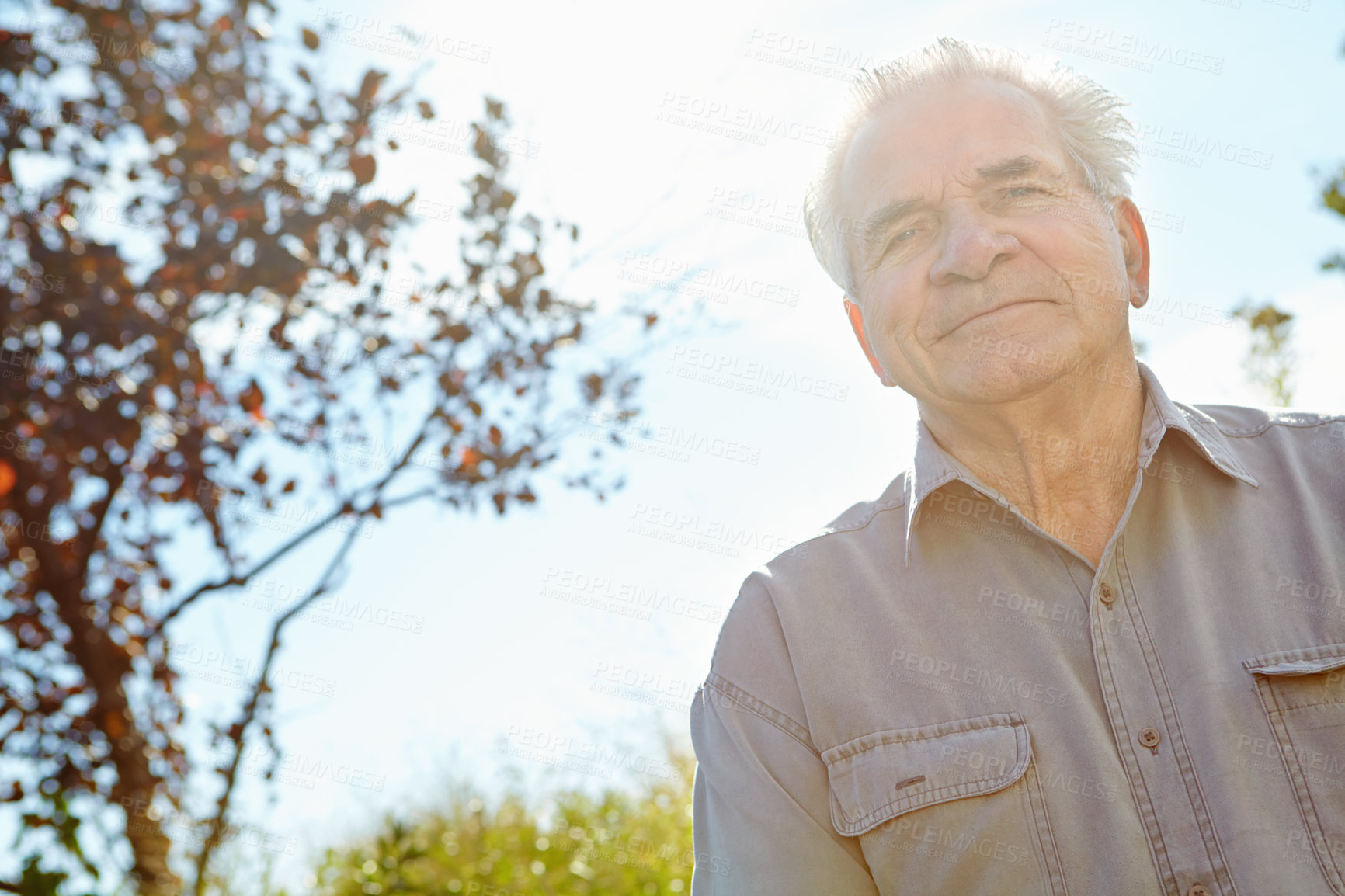 Buy stock photo Portrait, retirement and senior man outdoor in green nature for activity, travel or wellness. Blue sky, break and confident with happy old person in garden park for summer or weekend relaxation