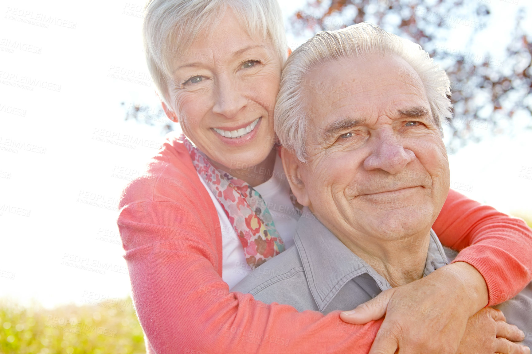 Buy stock photo A mature woman embracing her husband