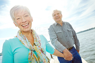 Buy stock photo A loving mature couple having a fabulous day outdoors by the lake