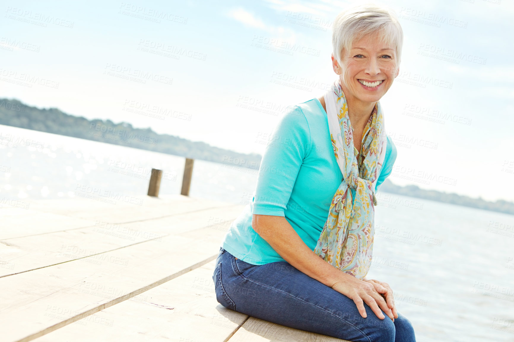 Buy stock photo Senior woman, lake and pier with portrait, water and relax on vacation with adventure for retirement. Mature person, happiness and holiday by river dock with nature, tourism and travel in Canada