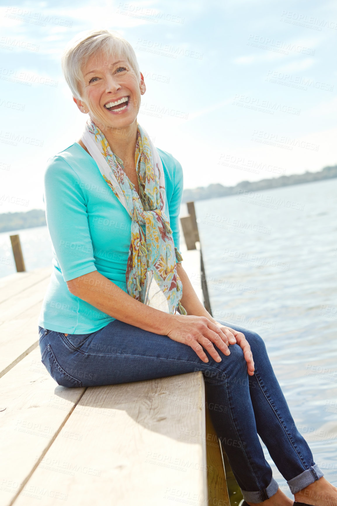 Buy stock photo Senior woman, lake and pier with laughing, water and relax on vacation with adventure for retirement. Mature person, portrait and holiday by river dock with nature, tourism and travel in Canada