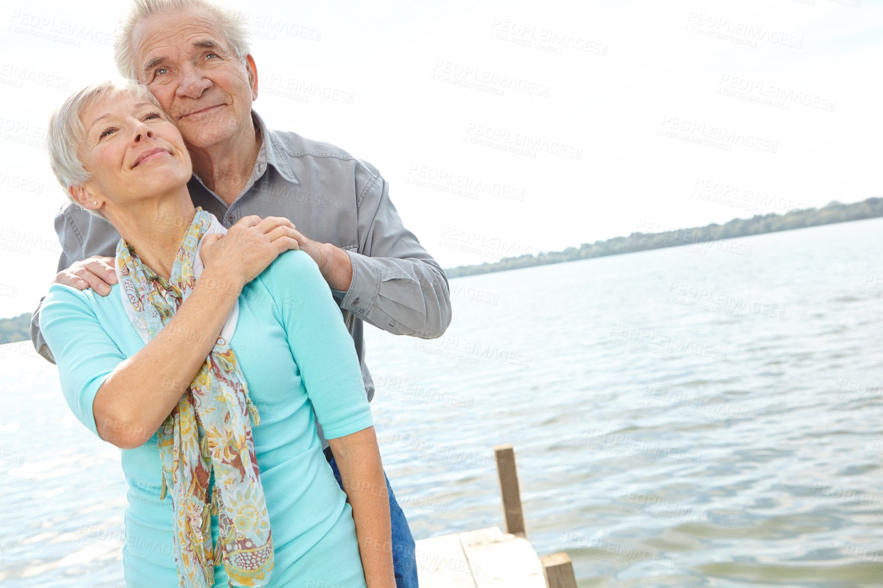 Buy stock photo Happy, travel and elderly couple at lake on holiday, relationship and connection for loyalty. Vacation, man and woman by water pier outdoor for support, love and thinking of marriage in retirement